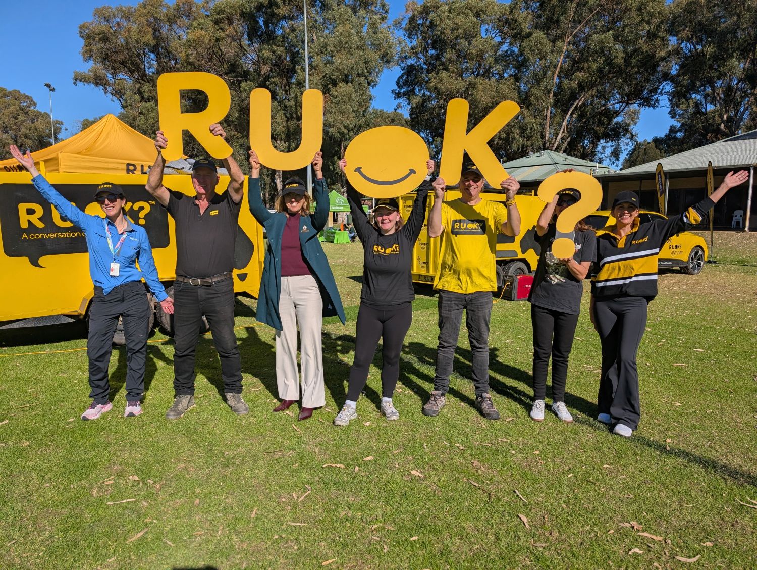 people holing up R U OK? sign